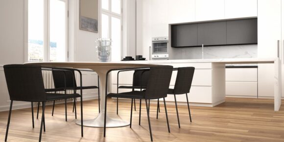 Modern kitchen and dining space with wood style floors showing how to clean Luxury Vinyl flooring for a smooth and well maintained finish.