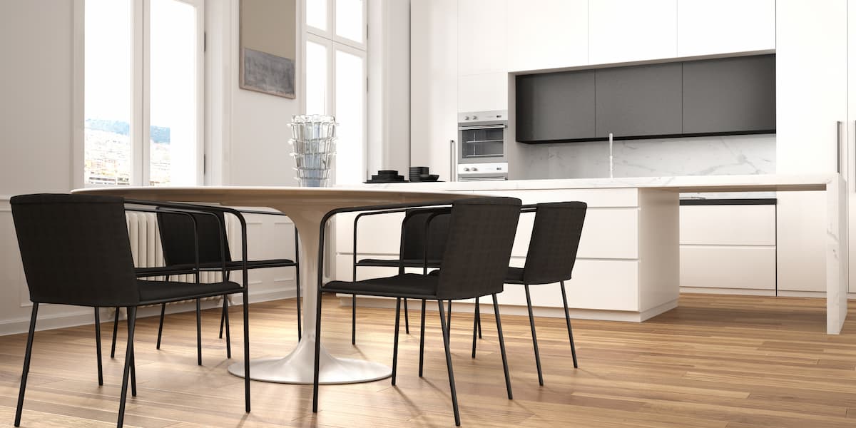 Modern kitchen and dining space with wood style floors showing how to clean Luxury Vinyl flooring for a smooth and well maintained finish.